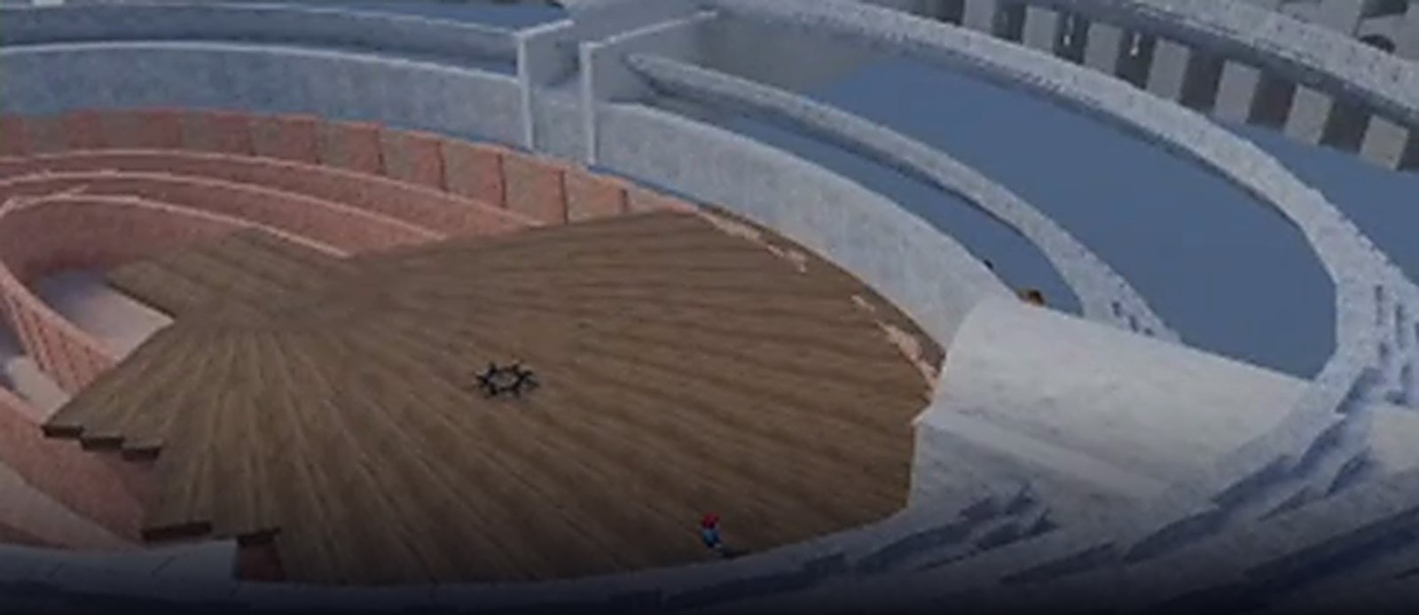 In-engine capture: a Roman amphitheatre — banked terracotta seating above a wooden arena floor, with the cross of the hypogeum showing through the boards.